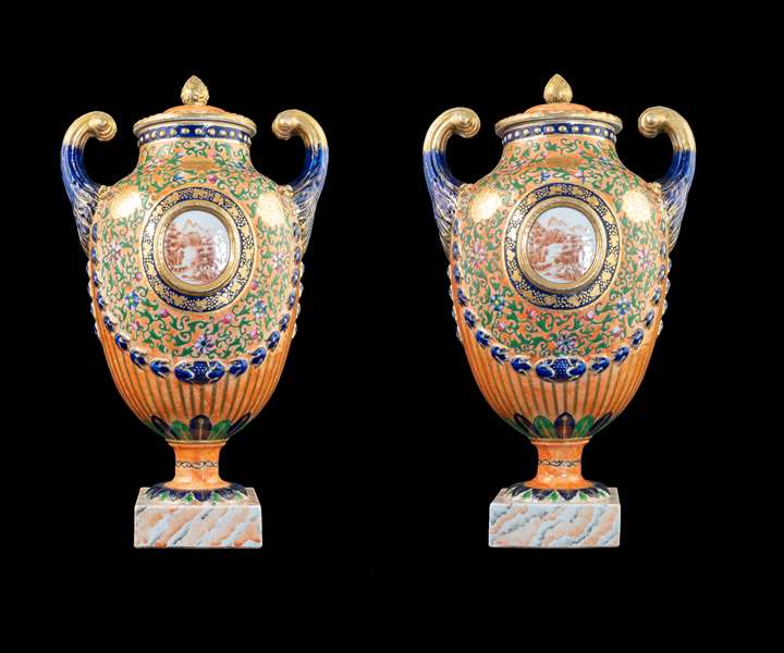 GG: Pair of Chinese export porcelain famille rose pistol handled urns and covers